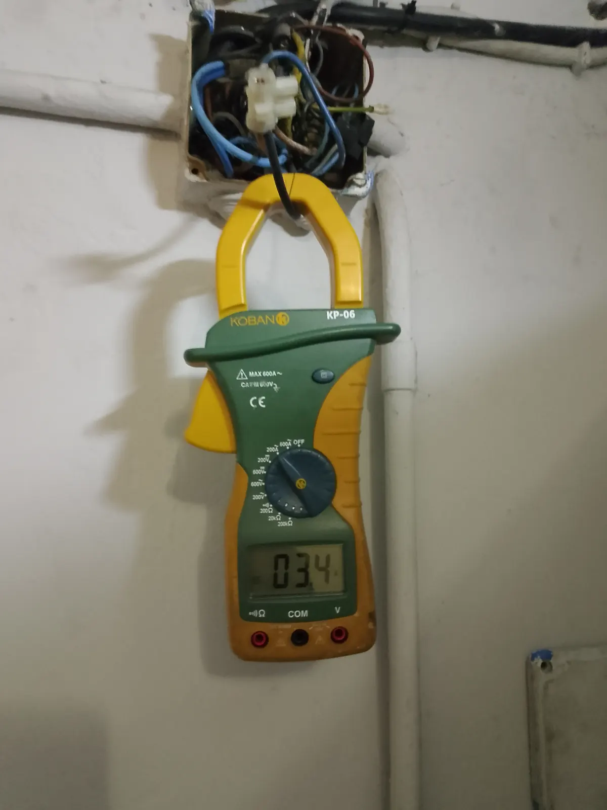 Pinça amperimètrica prenent una mesura en una revisió elèctrica.